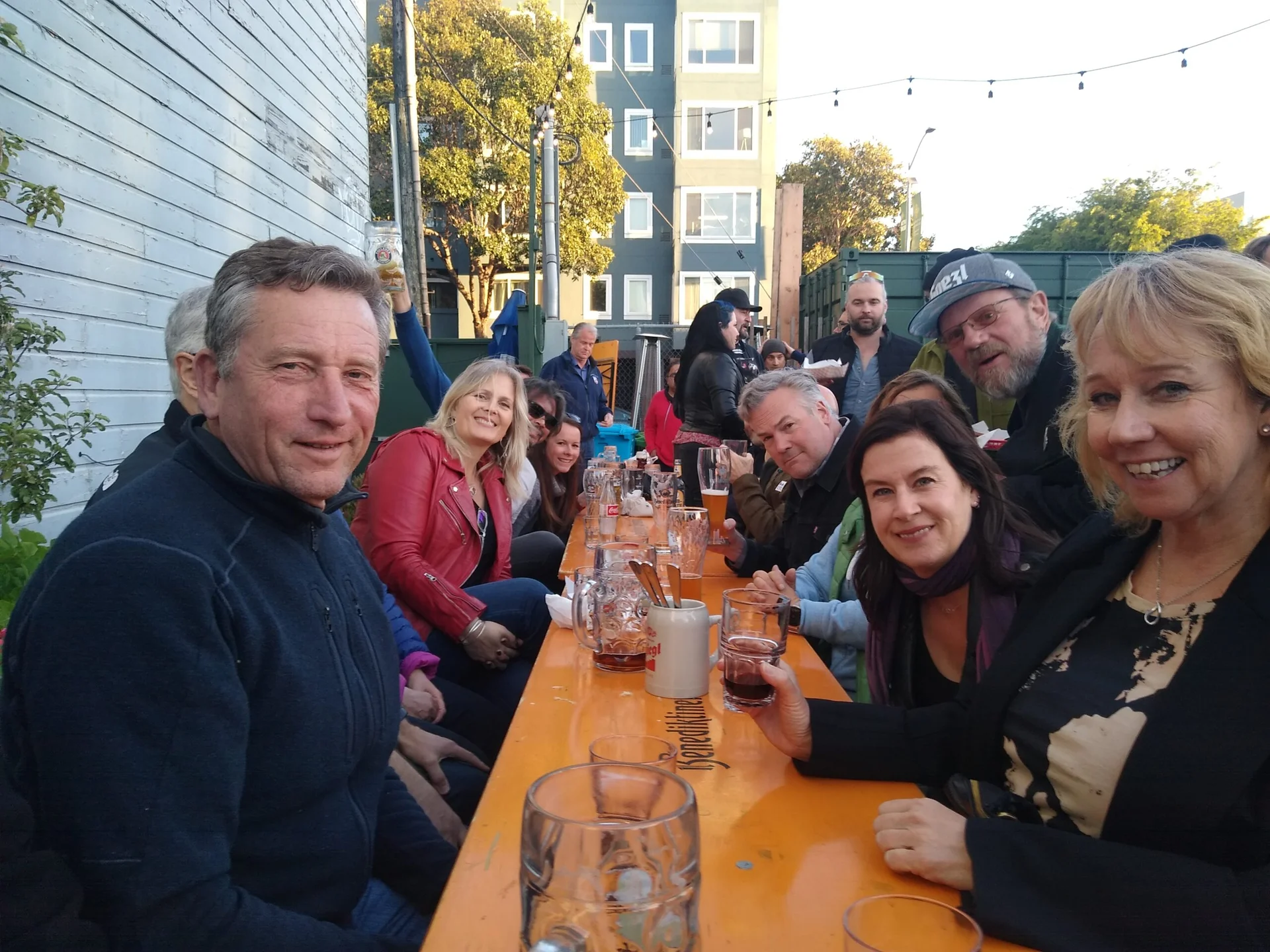 Happy Hour guests around an outside table