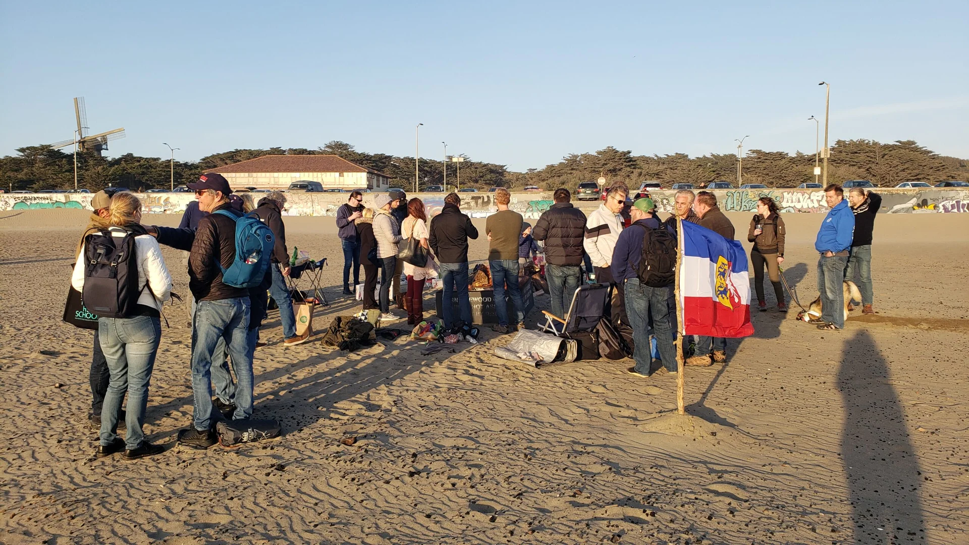 People starting bonfire on the beach to celebrate spring